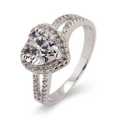 a white gold ring with an oval cut diamond and pave set diamonds around the band