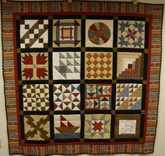 a quilt hanging on the wall in a room