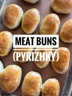 some bread buns on a baking sheet with the words meat buns pyrrizky