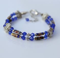 The bracelet is handmade using cloisonne and Czech crystal glass. The splendor of cloisonne will awe you with with its intricate pattern and the brilliant colors. The indigo blue is a very classic color for Chinese cloisonne. The length of the bracelet is 7-8 ¼ inches, 18-21cm. For matching earrings, please go to: https://www.etsy.com/listing/118477802/earring For matching necklace, please go to: https://www.etsy.com/listing/118477769/necklace ;-) Enter my shop here: http://www.etsy.com/shop/Ani Chinese Cloisonne, Lapis Lazuli Stone, Bridesmaid Bracelet, Gold Filled Earrings, Czech Crystal, Garnet Stone, Matching Necklaces, Indigo Blue, Heart Pendant Necklace