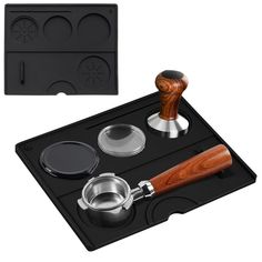 an assortment of kitchen utensils and accessories on a black tray with a wooden handle