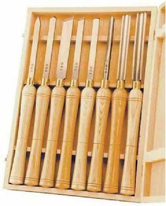 a wooden box filled with lots of different types of baseball bat's and bats