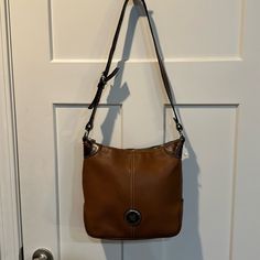 Excellent Used Condition Brown Dooney And Bourke Cross Body Bag With Adjustable Strap. Exterior Is In Excellent Shape. Interior Has Some Pen Marks. Please See All Pictures. Classic Brown Bag With Pebbled Texture, Tan Pebbled Leather Shoulder Bag For Everyday Use, Tan Pebbled Leather Bag For Everyday Use, Everyday Tan Pebbled Leather Bag, Brown Pebbled Leather Hobo Bag, Everyday Use Crossbody Bag With Pebbled Texture, Pebbled Texture Crossbody Bag For Everyday Use, Everyday Pebbled Texture Crossbody Shoulder Bag, Everyday Pebbled Texture Crossbody Bag