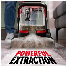 a person vacuuming the floor with a powerful extra action carpet cleaner on top of it