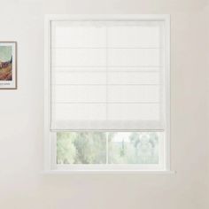 an empty room with a window and white blinds on the windowsill, in front of a painting