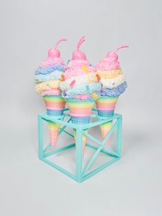 three ice cream cones sitting on top of each other