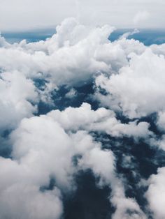 the view from an airplane looking down on clouds