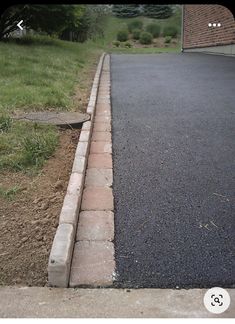 a fire hydrant sitting on the side of a road in front of a house