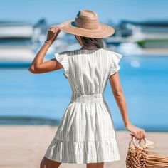 Flaunt your playful side in our Striped V-Neck Ruffled Mini Dress! Featuring chic stripes and charming ruffles, this dress is a perfect blend of casual and chic, ideal for sunny outings and carefree adventures all season long. Whether you're attending a brunch with friends or a special evening event, this dress will ensure you stand out with style and sophistication. Product code: CAA05A4E062CS Striped V-neck Sundress, Striped Short Sleeve Dress With Ruffles, Striped Mini Dress With Ruffles And Short Sleeves, Striped Ruffled Mini Dress For Vacation, Striped Ruffle Hem Dress For Vacation, Chic Striped Mini Dress With Ruffles, Striped Dress With Ruffle Hem For Vacation, Striped Summer Dress With Ruffle Hem, Striped Ruffle Dress For Day Out