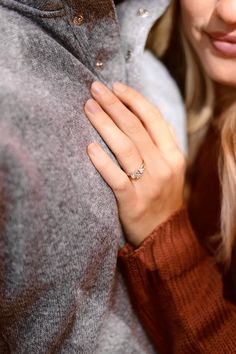 a man and woman embracing each other with rings on their fingers