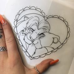 a woman's hand with an orange nail polish holding up a drawing of a lion