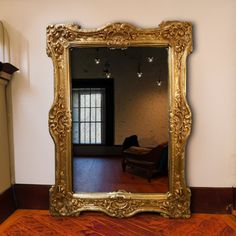 a mirror sitting on top of a wooden floor