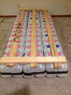 several plastic bottles stacked on top of each other in a room with carpeted flooring