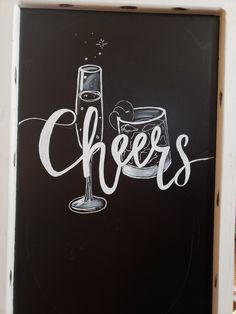 a chalkboard sign with the words cheers written on it