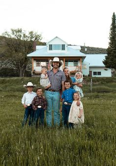 a man standing in the middle of a field with children