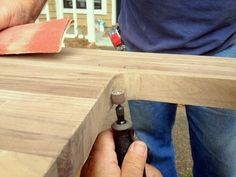 a man is working on a piece of wood