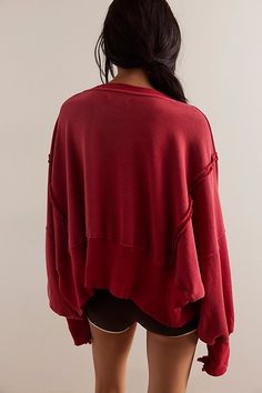 Forever cool and classic, this cropped sweatshirt is featured in a slouchy, relaxed fit with wide scoop neckline, defined seaming and lower back hem for added shape. **Fit:** Relaxed, slouchy fit **Features:** Wide scoop neckline, defined seaming, ribbed hems, distressing throughout **Why We | We The Free Camden Cropped Sweatshirt at Free People in Red, Size: XS Exaggerated Sleeves, Cropped Crewneck, Red Fits, Cotton Farming, Pullover Designs, Crop Sweatshirt, Boho Clothing, Hoodie Top, Dolman Sleeve