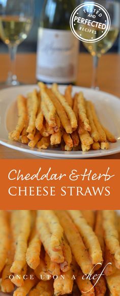 cheddar and herb cheese straws on a plate with wine in the background