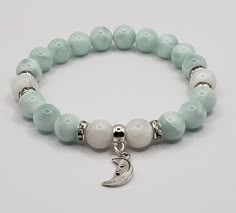 "High quality, genuine, Natural, AAA grade green moonstone bracelet, combined with white moonstone beads and crystal rondelle spacers and a moon charm. I didn't know green moonstone exist in a natural form, when I found out about this beauty, I had to make a green moonstone bracelet.. :) Such a beauty and so elegant! It's real and natural so that light green /mint color is it's natural color, not treated or dyed in any way. The white moonstone beads are also natural and high quality.. Made with White Moon-shaped Bracelets For Gifts, White Moon Shaped Bracelet Gift, Moon Shaped White Bracelets For Gifts, White Moon Shaped Bracelets For Gift, Moon Shaped White Bracelet For Gift, Adjustable White Moon Bracelet, Adjustable White Moon Shaped Bracelets, Adjustable White Moon-shaped Bracelets, White Jade Crystal Bracelet With Natural Stones