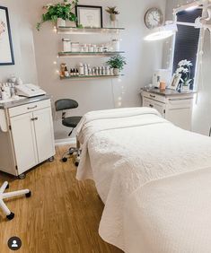 a room with a bed, desk and shelves on the wall next to each other