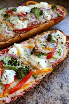 two slices of pizza with cheese, broccoli and peppers