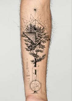 a man's arm with a tree and geometric shapes on it