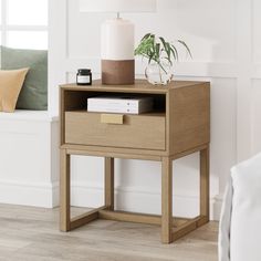 a small wooden table with a plant on top