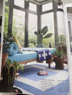 an open magazine with a bed and potted plants