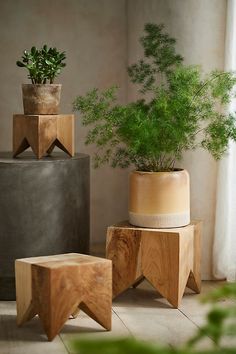 three wooden planters sitting next to each other on top of a tile covered floor