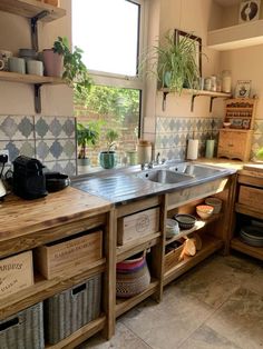 a kitchen filled with lots of wooden drawers next to a sink and stove top oven