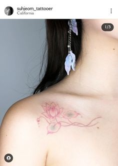 a woman's chest with a flower tattoo on the left side of her shoulder