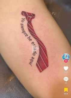 a red ribbon tattoo on the leg with words written below it that reads, to heaven we are one step up and down