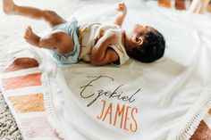 a baby laying on top of a blanket with the words epeeled james printed on it