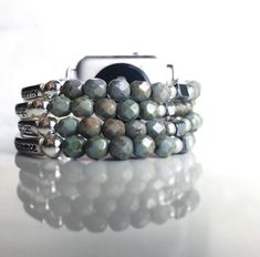 "Elegant and simply beautiful Serenity Prayer beaded Apple iWatch band. Features your choice of colored beads with silver tone accents. This band fits as a bangle - with just enough room so it's not snug and also won't move too freely on your wrist. Colors can be customized - please DM me. This Apple watch band is designed to put on as a regular watch (attach watch face, place on wrist, wrap band around wrist and slide adapter into place). Color Options: custom color options are available! Pleas Trendy Silver Beaded Watch Band, Silver Adjustable Apple Watch Band With Round Beads, Adjustable Silver Beaded Apple Watch Band, Adjustable Silver Beaded Watch Bands, Silver Beaded Bracelets With Round Beads, Prayer Bracelet, Iwatch Apple, Band Fits, Serenity Prayer