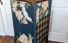 an old cabinet with flowers painted on it