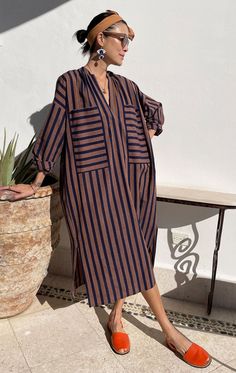 A modern chic caftan inspired by Moroccan tones in an opaque lightweight handwoven cotton. Offers good coverage + two large front pockets. So comfortable you won't want to take it off! Handwash cold.  Color:  navy and peachy pink —  Lightweight Handwoven cotton —  Width 26" flat  / Length 47" with sleeve —  Chic slimme Mode Kimono, Moda Vintage, Peachy Pink, Packing Tips For Vacation, Modern Chic, Packing Tips, Look Fashion, Striped Dress, African Fashion