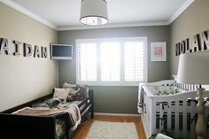 a baby's room with two cribs in it