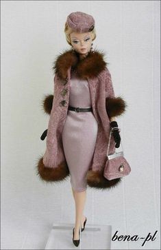 a barbie doll wearing a pink dress and fur coat