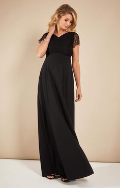 Eleanor is the ultimate full length maternity gown for the most special occasions. A perfectly tailored bodice in exquisite leavers lace, with intricate detailing to the shoulders and sleeves, flows into a fully dramatic, opulent skirt with the most beautiful drape. •Wonderful heavyweight matte crepe satin •Full length opulent skirt for dramatic swish •Feminine subtle v-neck •Scalloped sleeve detail •Concealed back zip •Intricate shoulder detail • Lovingly designed and made in Britain Elegant Dress With Lace Top And Fitted Bodice, Elegant Floor-length Dress With Lace Trim, Gala Gown With Scalloped Lace And Fitted Bodice, Elegant Floor-length Evening Dress With Scalloped Lace, Gala Lace Dress With Fitted Bodice And Lace Sleeves, Gala Lace Dress With Fitted Bodice, Elegant Floor-length Evening Dress With Lace Trim, Fitted Bodice Maxi Dress With Lace Back, Floor-length Lace Dress With Lace Trim For Formal Events