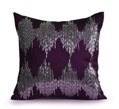 a blue pillow with silver sequins on it