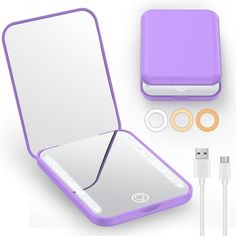 an open purple case with ear buds and charger next to it on a white surface