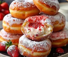 strawberry cream filled donuts stacked on top of each other