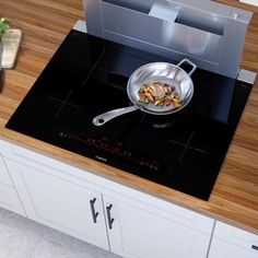 a frying pan on top of a stove with food cooking in the skillet