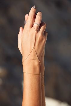 This dainty bracelet has been handcrafted from the highest quality 925 silver and is available in pure silver or gold plated with 24 carat gold. Minimalistic and exquisite, the Sanje bracelet is a timeless piece, suiting any outfit and occasion. Its geometrical shape makes it ever more striking, adding a special touch to anything you wear it with. Here worn with our Ular bracelet. Please note: We recommend adjusting the extension chain around your wrist to your desired length, however making sur Dainty Adjustable Bracelet Body Jewelry, Dainty Adjustable Body Jewelry Bracelet, Adjustable Delicate Chain Body Jewelry As Gift, Adjustable Dainty Body Jewelry, Adjustable Delicate Chain Body Jewelry For Gift, Minimalist Sterling Silver Bracelet Strap Jewelry, Minimalist Sterling Silver Jewelry With Bracelet Strap, Dainty Body Jewelry With Delicate Chain For Gifts, Adjustable Delicate Body Jewelry With Chain