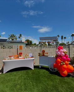 an outdoor party with balloons and decorations