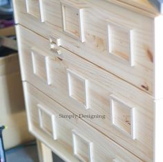 the drawers are made out of wood and have square holes in each drawer to make them look like they were built from plywood