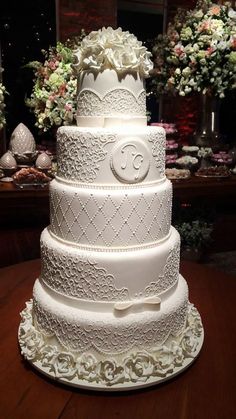 a large white wedding cake sitting on top of a table