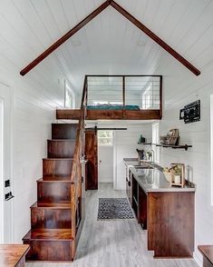 the interior of a tiny house with stairs