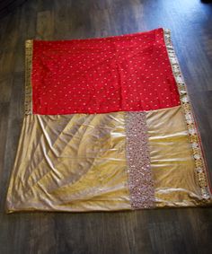 *Red with black and gold border and gold beading *Pleats of the saree is gold metallic material & the top half/pallu is red. *Material: Georgette & Lycra *Blouse Not Included *Color May Vary Slightly from picture *Our store is located in Los Angeles and in-store pick up is welcome *Returns not accepted *Single item available Red Chinon Traditional Wear For Puja, Festive Red Pre-draped Saree For Puja, Red Festive Saree For Diwali, Bollywood Style Gold Traditional Wear With Mirror Work, Gold Embroidered Saree For Diwali, Red Saree With Dupatta For Celebration, Bollywood Style Gold Pre-draped Saree With Pallu, Bollywood Style Red Sharara For Puja, Red Bollywood Sharara For Puja