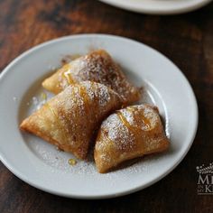 two plates with pastries on them sitting on a table